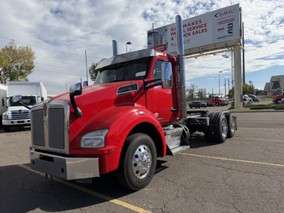 Kenworth T880 (2020) conventional daycab truck in red, front-left view, with dual rear axles and chrome fuel tanks, VIN tag not visible.