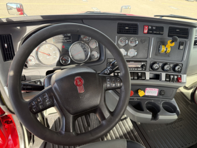 Kenworth T880 interior dashboard and steering wheel with multiple gauges and control switches.