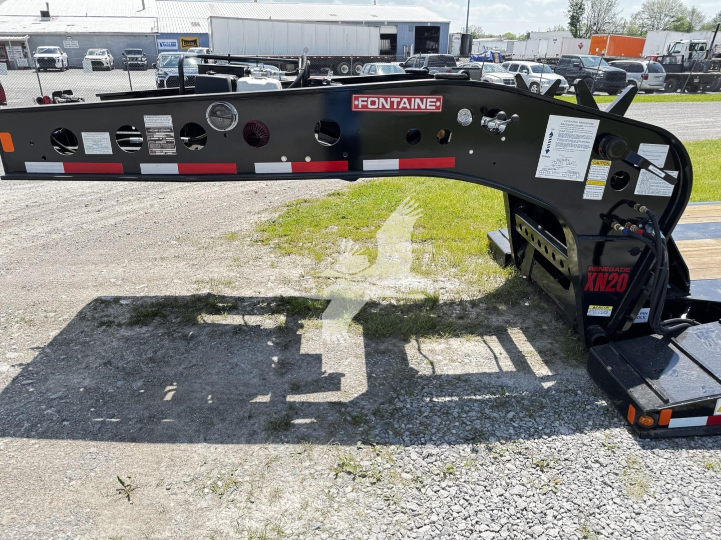 Fontaine XN20 lowboy trailer front rail showing Fontaine logo and model tag with VIN/V35A7132 information in the background