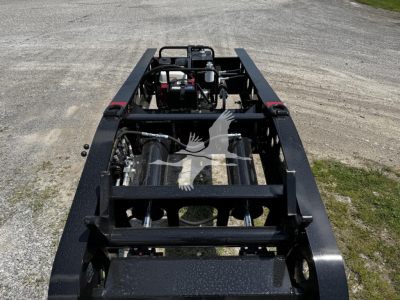 Fontaine XN20 lowboy trailer frame showing chassis and mounting components with engine-like visible parts and hydraulic lines.