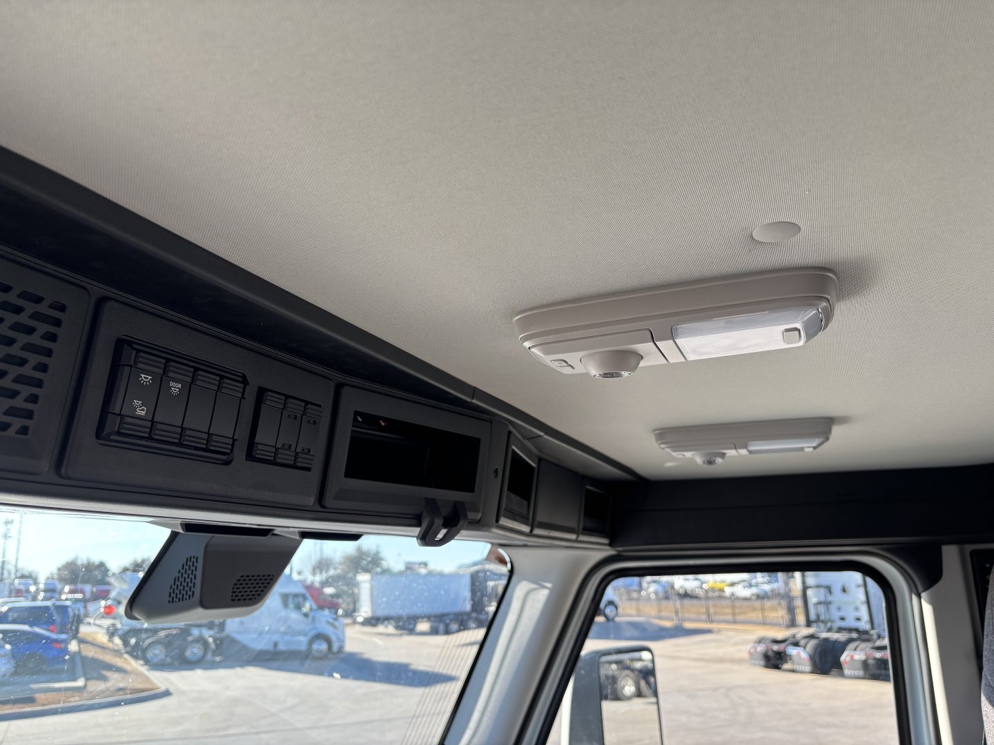 Mack PR64T cab interior showing overhead console and ceiling-mounted lights.