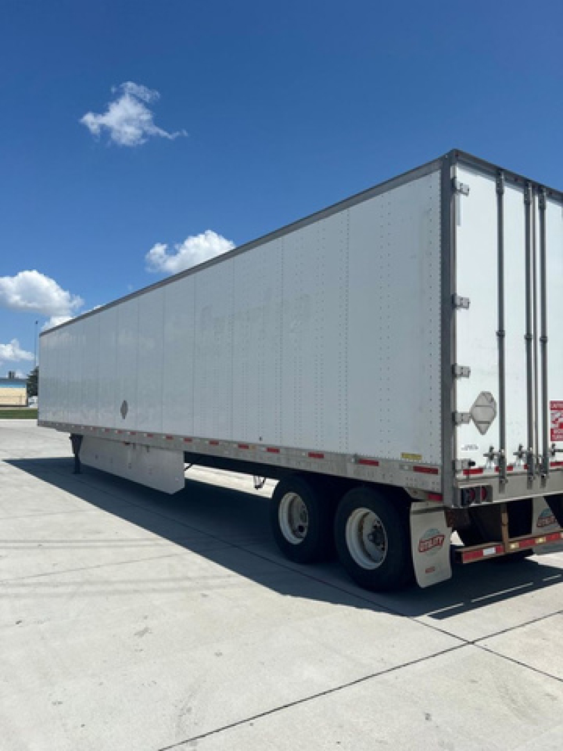 Trailer side view showing enclosed box with dual rear doors and wheels undercarriage, utility van trailer. Visible text not legible.