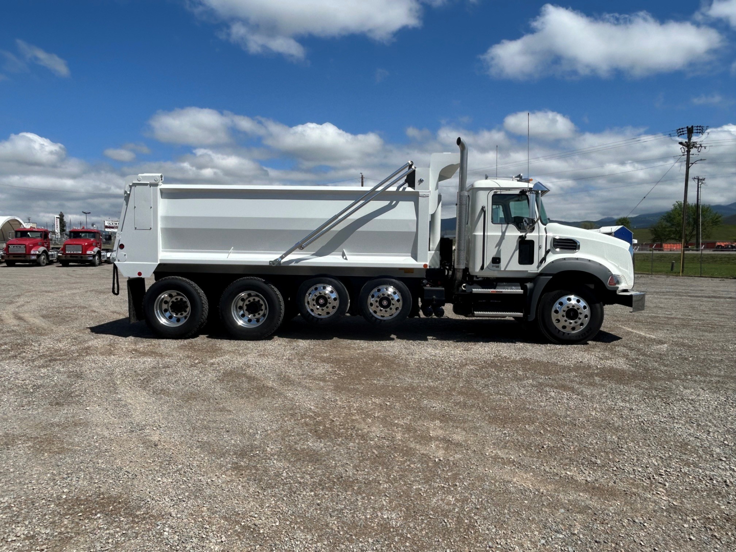 Mack GR104B dump truck side view showing six-wheel rear tandem and dumping bed
