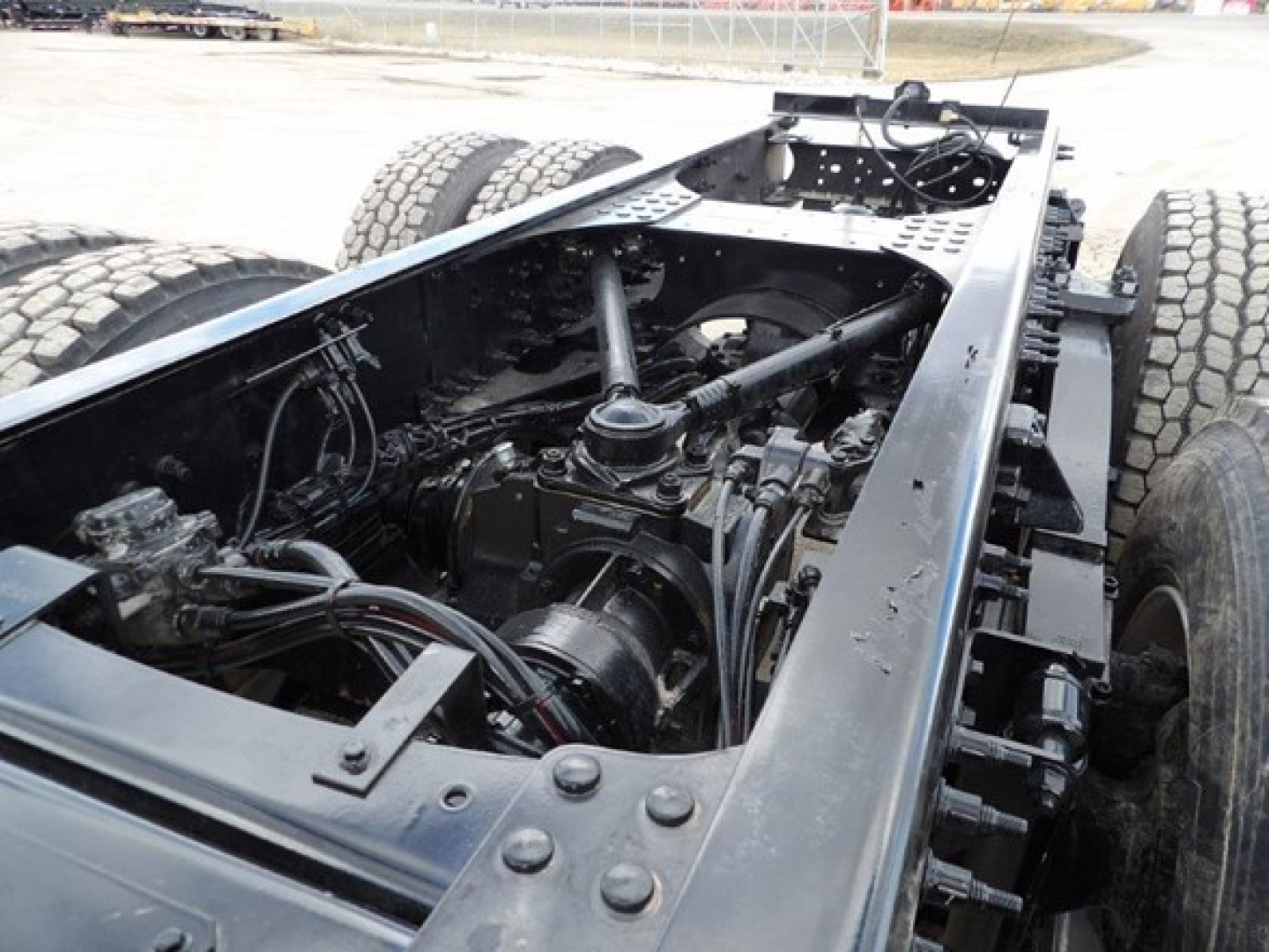 Mack GR64B cab and chassis undercarriage showing drivetrain and rear axle with suspension and frame rails.