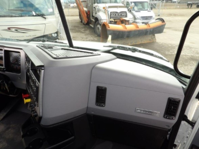 Cab interior of a 2025 Mack GR64B showing dashboard and glove box area with Gr80 air intake vents