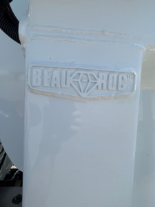 BeauRock branded component on Mack GR104B dump truck showing embossed BeauRock logo.