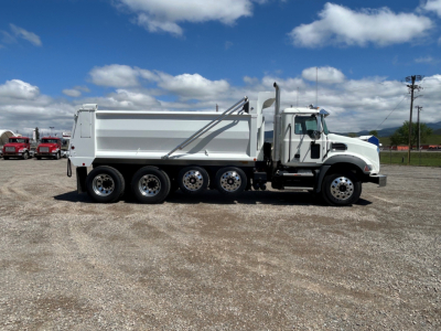 Mack GR104B dump truck side view showing six-wheel rear tandem and dumping bed