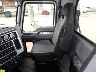Cab and chassis interior of 2025 Mack GR64B showing dashboard gauges and driver seat with window view.