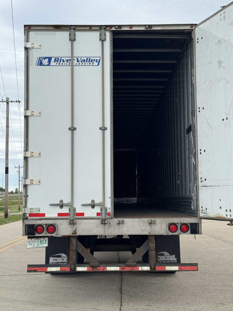 Utility trailer 4000D-X rear view with open doors showing interior, River Valley trailer logo on left door, rear lights and bumper, license plate area visible.