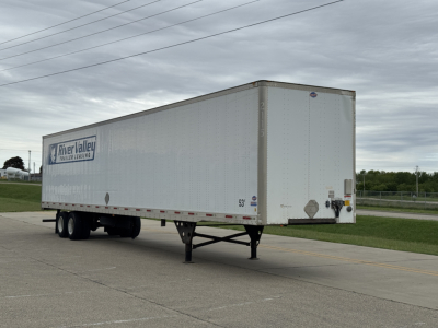 Trailer side view showing River Valley Trailers logo on a white box with landing gear and dual rear doors.