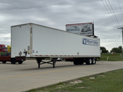 Trailer: white utility 4000D-X trailer with River Valley Trailers logo parked in a lot.