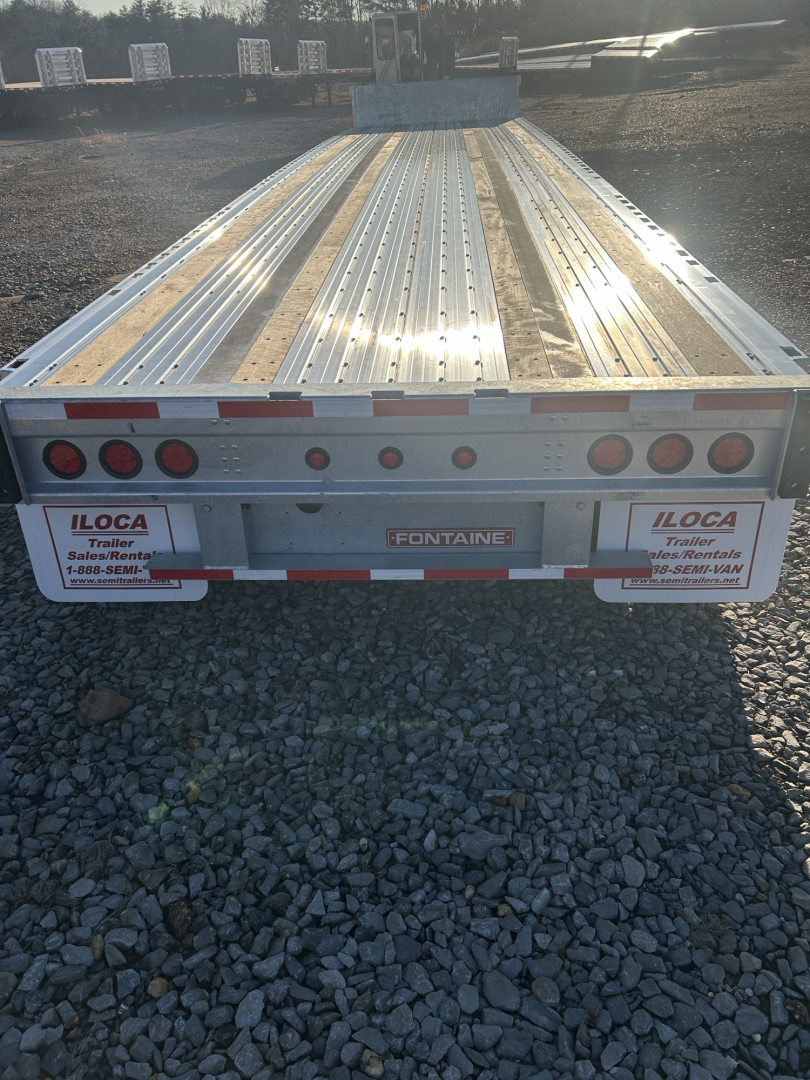 Trailer rear view showing 48' combo drop deck with galvanized steel deck and wide-spread axles; Fontaine branding and ILoca dealer stickers visible on tailgate; multiple red tail lights and reflective tape.