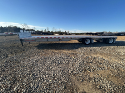 New Fontaine 48' combo drop deck trailer with galvanized frame and wide-spread axle, side view showing dual rear axles and reflective tape.
