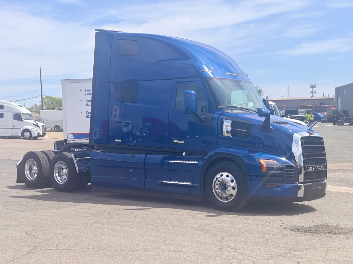 2027 Mack PR64T76H truck in blue side view showing cab with lifting sleeper, front grille, and wheels.