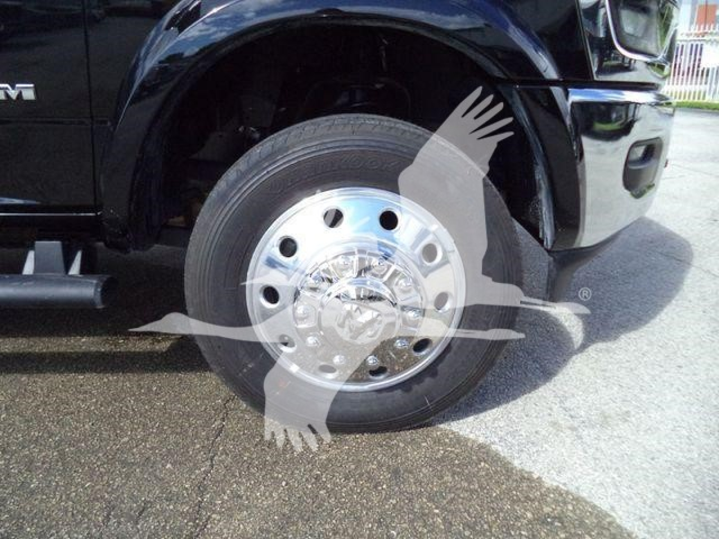 Truck wheel and hub showing 2026 Ram 4500 Big Horn with chrome wheel, tire and fender; partial cab and side step visible.