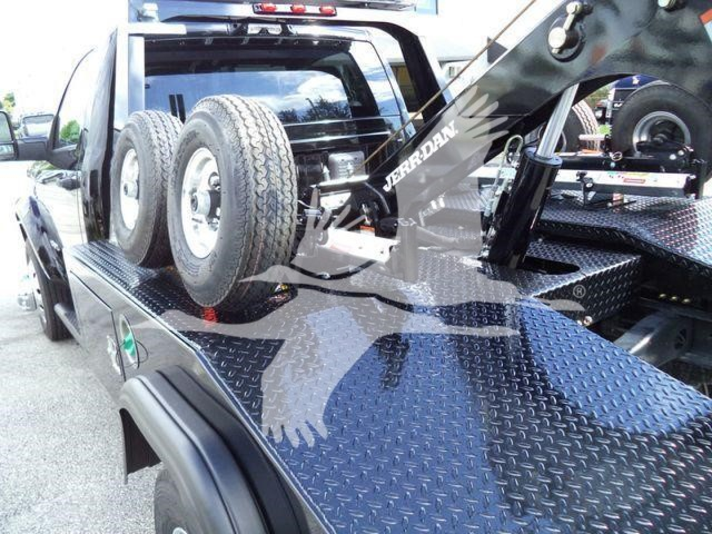 Ram 4500 Big Horn tow truck bed with dual rear wheels and heavy-duty winch/boom system visible on diamond plate bed.