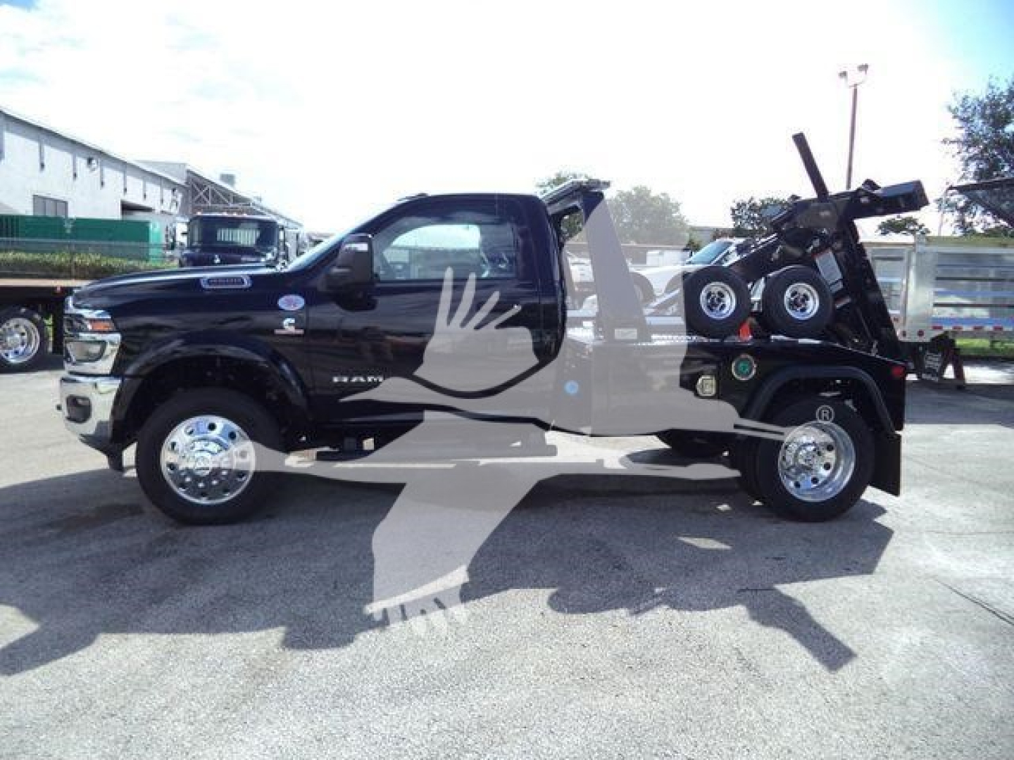 Ram 4500 truck with winch equipment, black exterior, long bed, side view showing cab and extended wheelbase, logo badges visible.