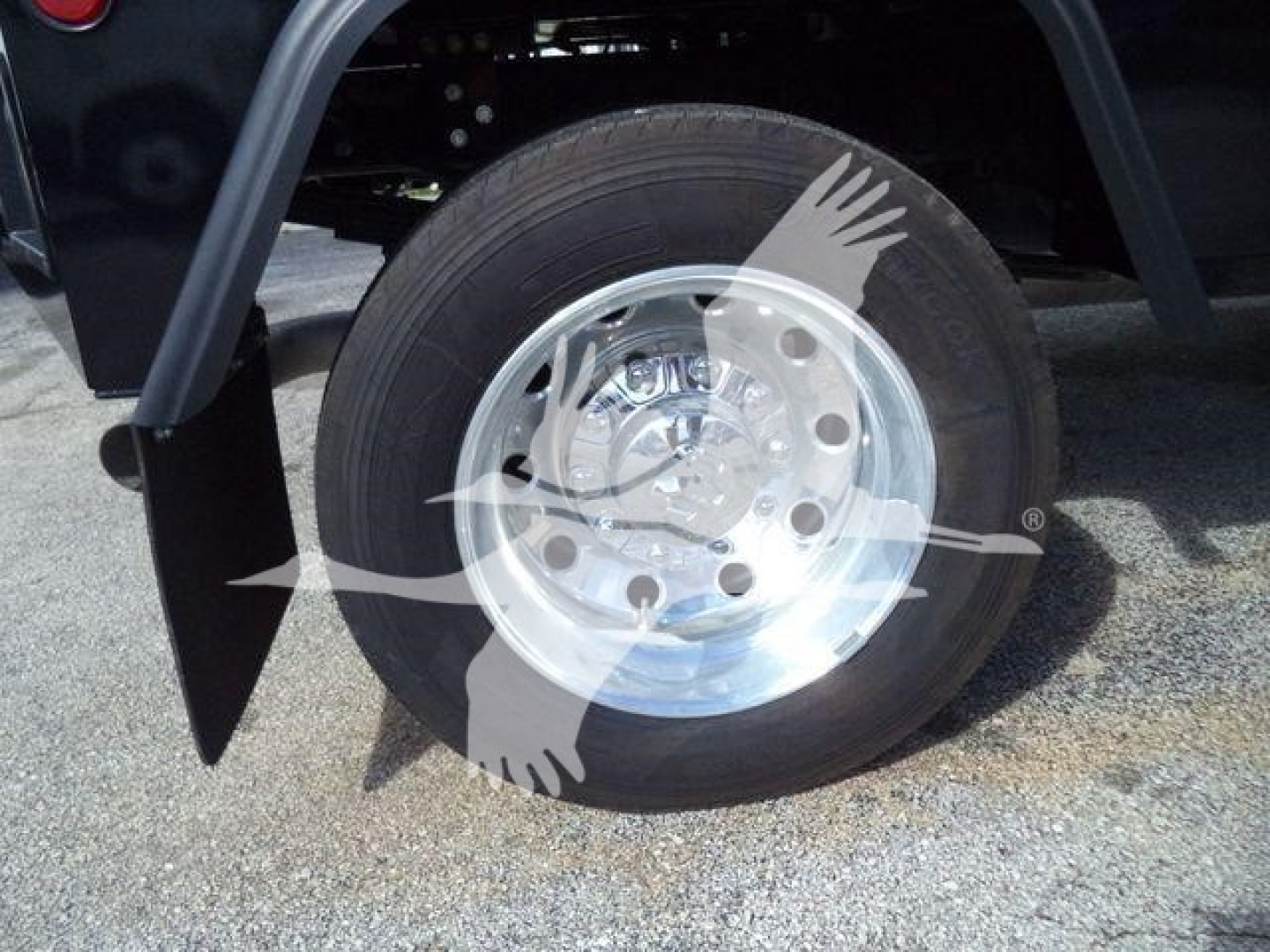 Wheel and hub of a new Ram 4500 Big Horn truck showing polished steel wheel with black tire and fender nearby.