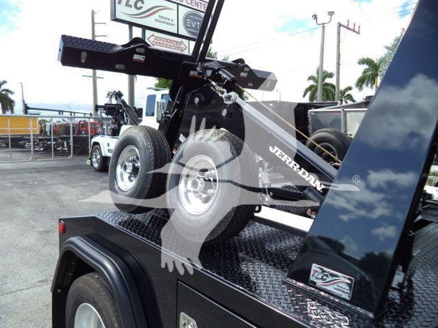 Truck bed with a mounted crane or winch system in the foreground, Ram 4500 Big Horn branding visible, wheel and metallic diamond plate surface.