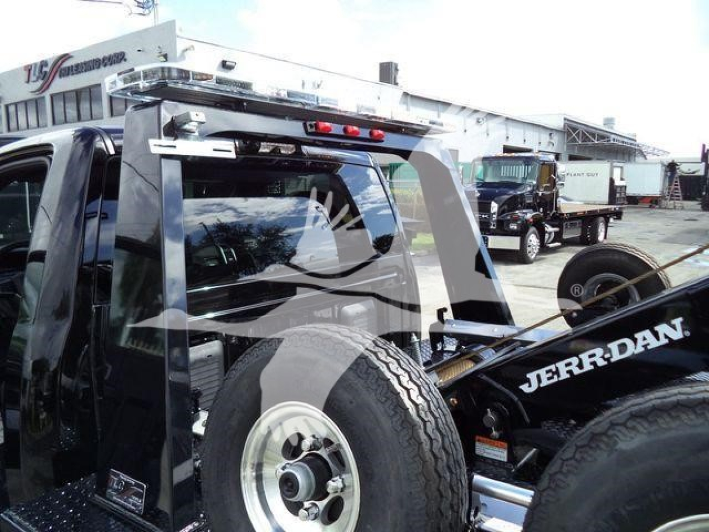 Ram 4500 truck with a mounted winch system and spare tire, rear cab view, Jerr-Dan tow equipment visible.