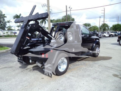 Ram 4500 Big Horn tow truck/flatbed with winch and hydraulic crane in bed, side view showing towing equipment and black cab