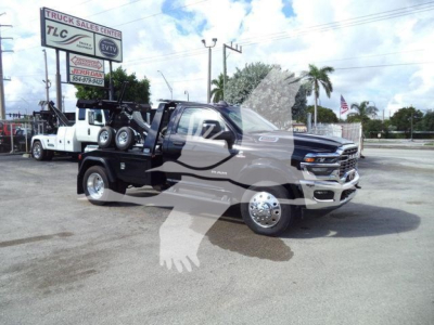 Ram 4500 tow truck with winch setup in a dealership lot, big horn badge visible, stock number BIGHORN4500NGS.