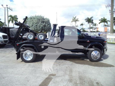 Ram 4500 tow truck with flatbed in-service showing 4500 badge and wheel details.
