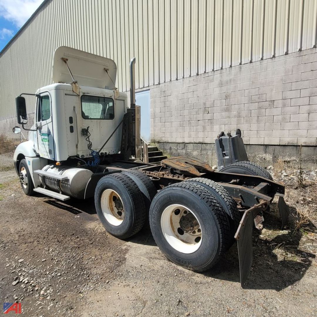 Freightliner Columbia 120 chassis with cab and rear wheel setup visible; tag shows parts-only truck with missing sleeper; white cab, dual rear axles, exposed frame rails.