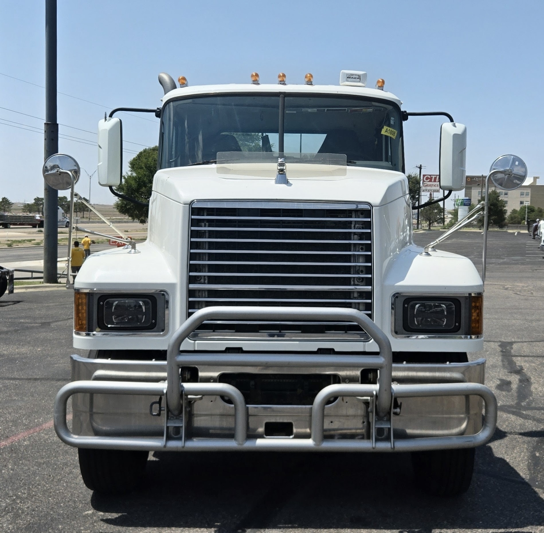 Front view of a white 2020 Mack PI64T conventional daycab truck showing grille, bumper guard, and large rectangular headlights.