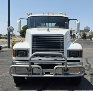 Front view of a white 2020 Mack PI64T conventional daycab truck showing grille, bumper guard, and large rectangular headlights.