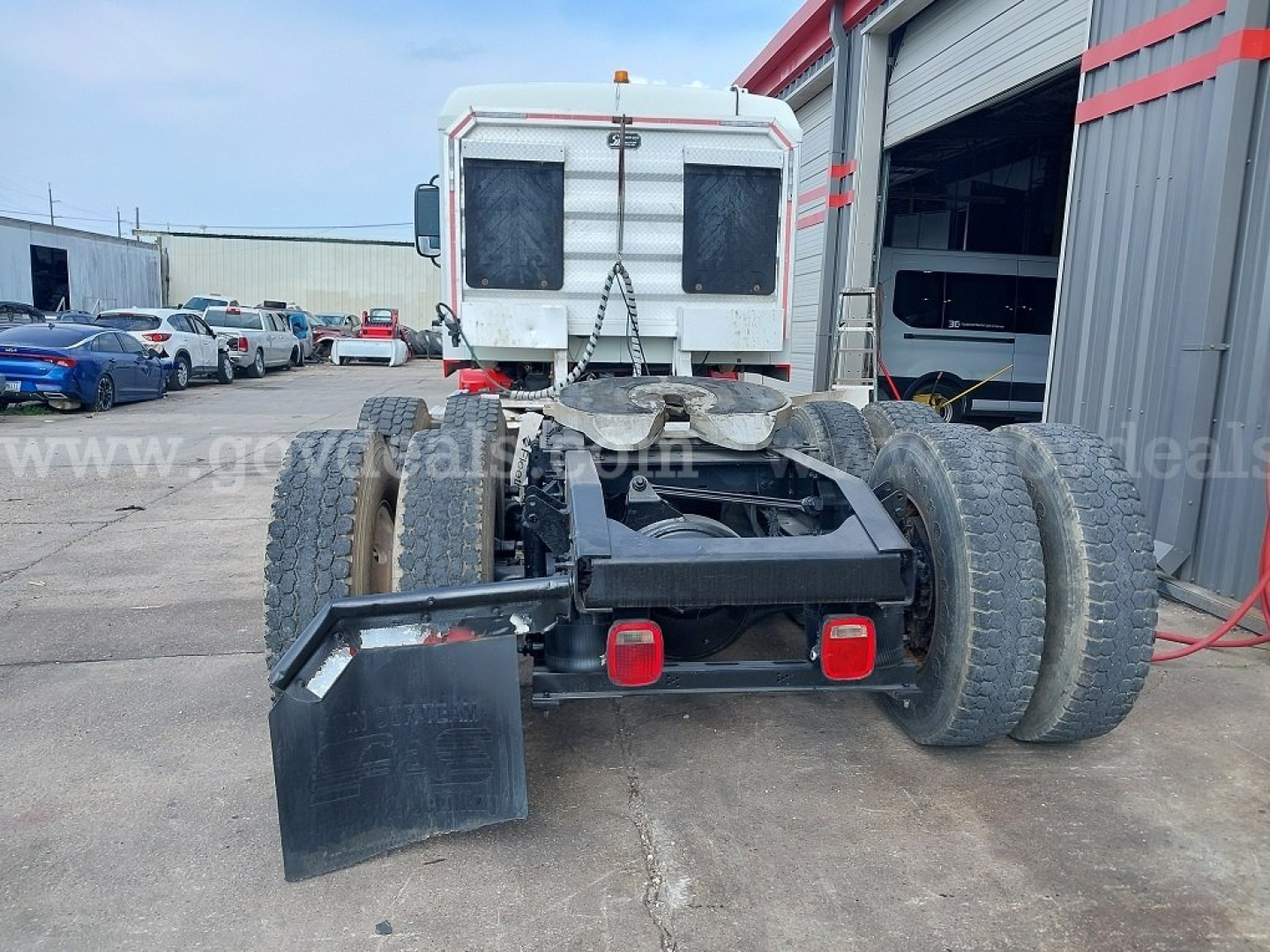 Rear view of 2014 Mack Pinnacle cab and chassis showing multiple rear dual wheels, bumper lights, and mud flaps.