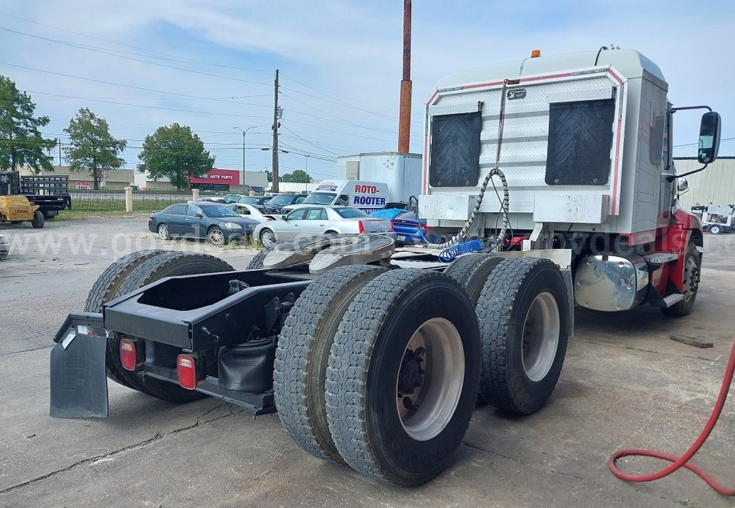Mack Pinnacle cab and chassis rear view showing triple rear axles with large tires and chassis frame.