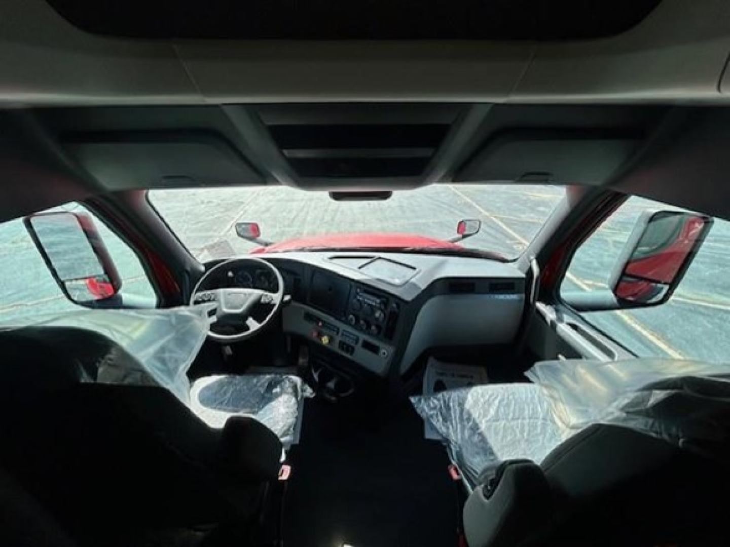 Freightliner Cascadia 126 truck interior shown from front cabin view with steering wheel and dashboard.