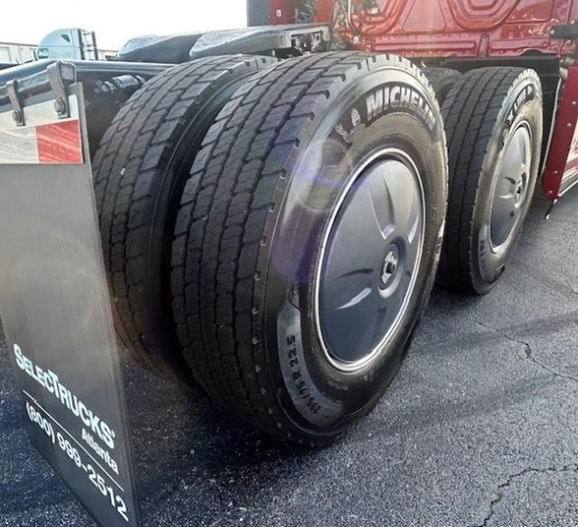 Freightliner Cascadia 126 truck rear dual wheels showing Michelin tires and wheel covers.