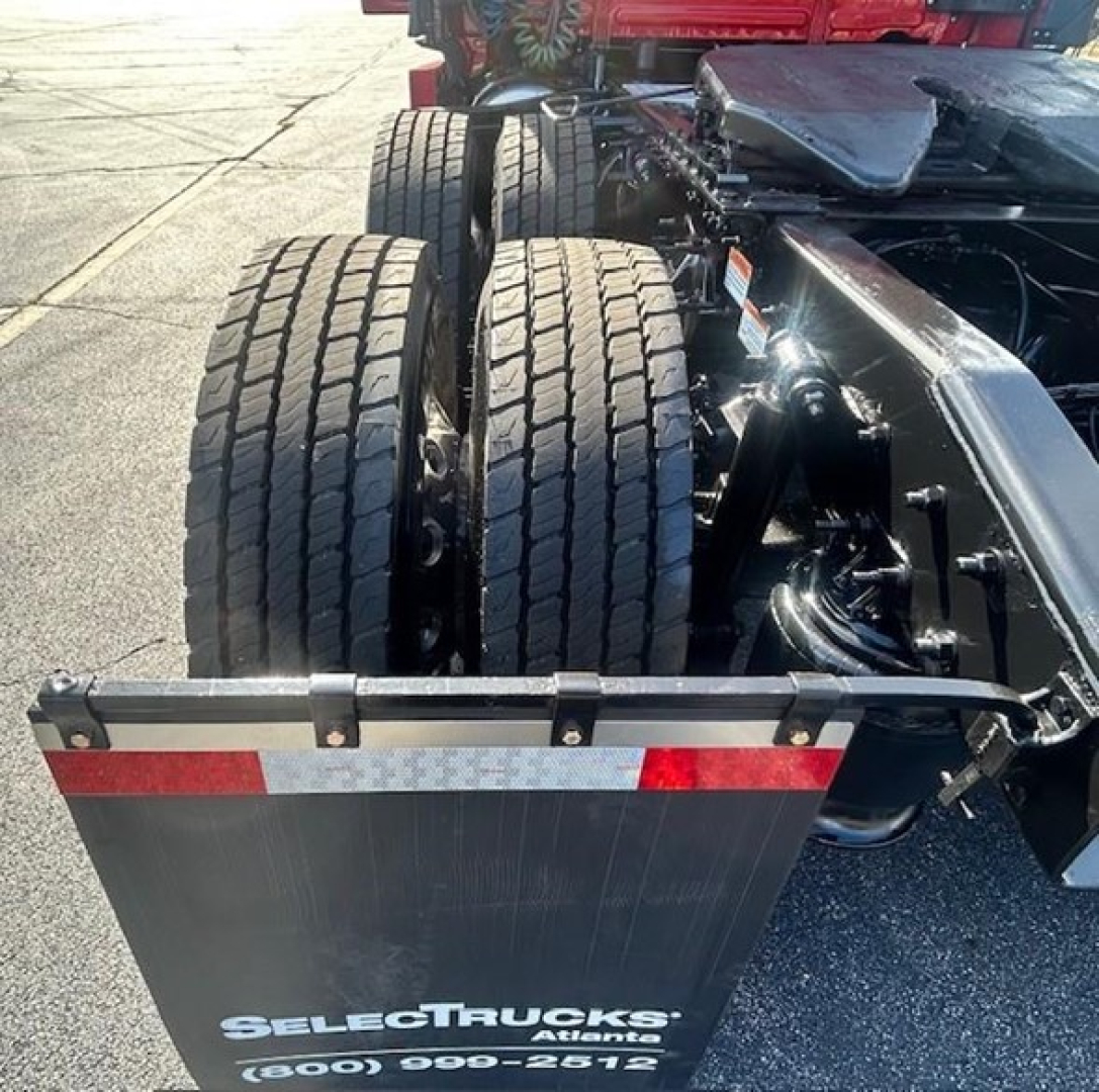 Rear view of a 2022 Freightliner Cascadia truck chassis showing dual rear wheels, frame, and mudflap with SelectTrucks Atlanta branding.