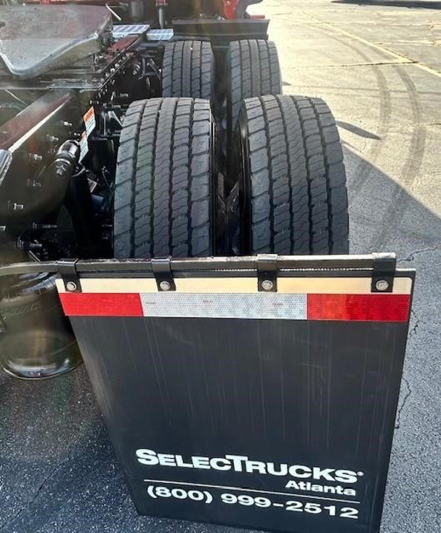 Rear view of a Freightliner Cascadia tractor showing dual rear axles and a SelectTrucks Atlanta plate with contact number.