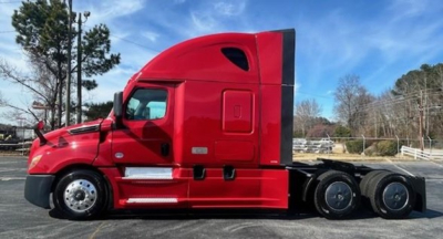 Truck side view showing a red Freightliner Cascadia 126 sleeper cab tractor with multiple rear axles.