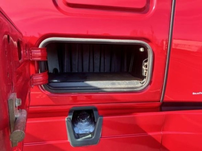 Freightliner Cascadia 126 fuel/air intake area near door, visible open cubby and side panel