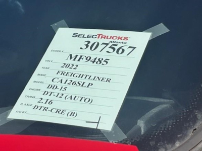 Tag on Freightliner Cascadia windshield with stock number 307567, VIN MF9485, 2022 model, CA126SLP, DD-15 engine, DT-12 (AUTO) transmission, 2.16 rear gear, DTR-CRE (B).