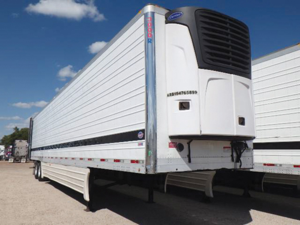 Utility reefer trailer showing Carrier refrigeration unit at front and side-mounted door rails.