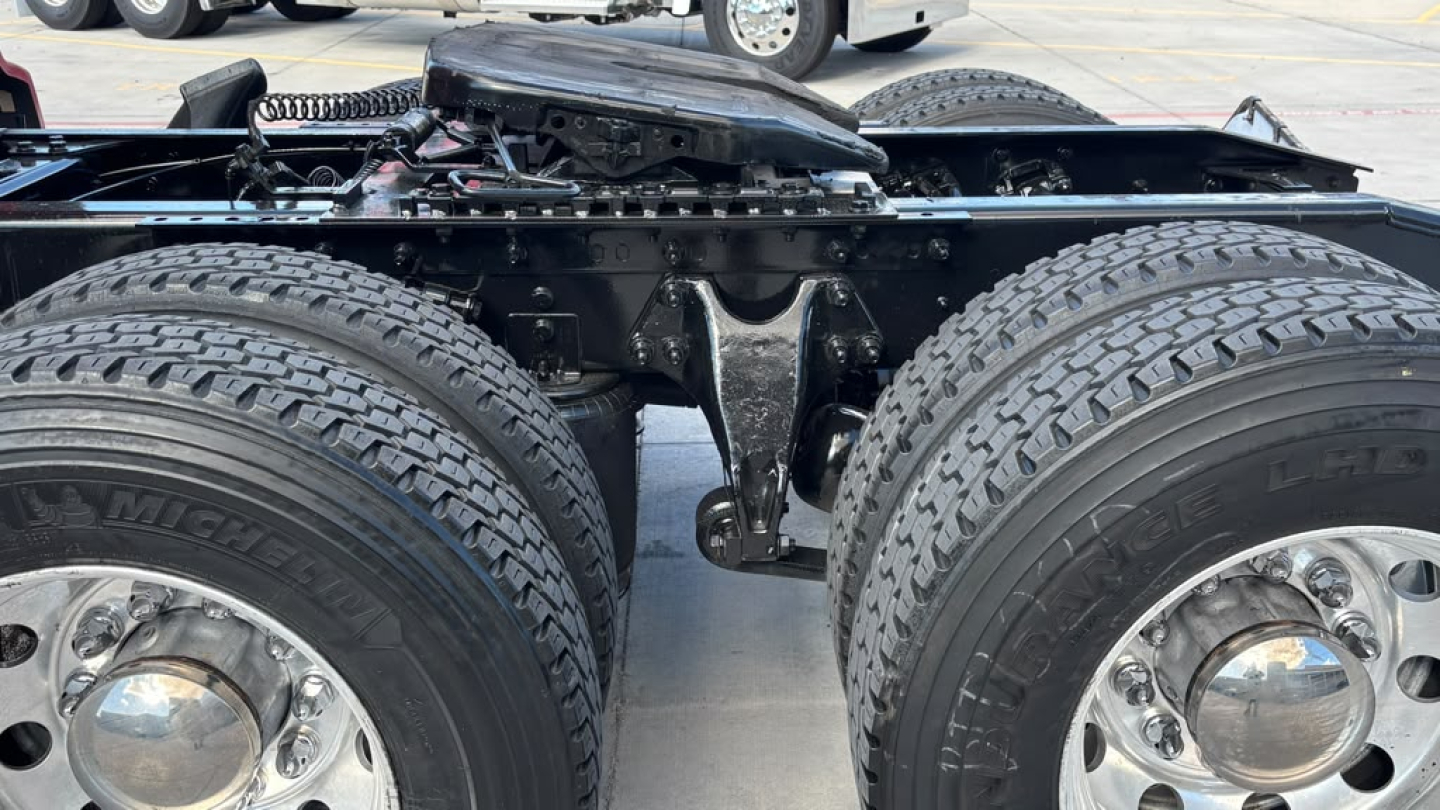 Truck chassis showing dual rear axles with Michelins tires, fifth-wheel area, and suspension components visible in a used 2022 International LT625 listing.