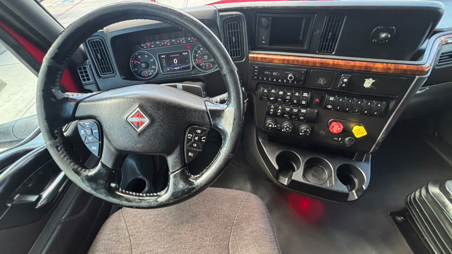 Interior cabin view of a 2022 International LT625 with steering wheel, dashboard, and center console showing gauges and controls.