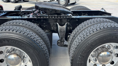 Truck chassis showing dual rear axles with Michelins tires, fifth-wheel area, and suspension components visible in a used 2022 International LT625 listing.