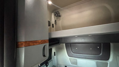 Cab interior of a 2022 International LT625 truck showing sleeper area and storage compartments.