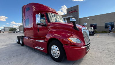 Truck exterior: red 2022 International LT625 sleeper cab, front three-quarter view, chrome wheels, no visible damage.