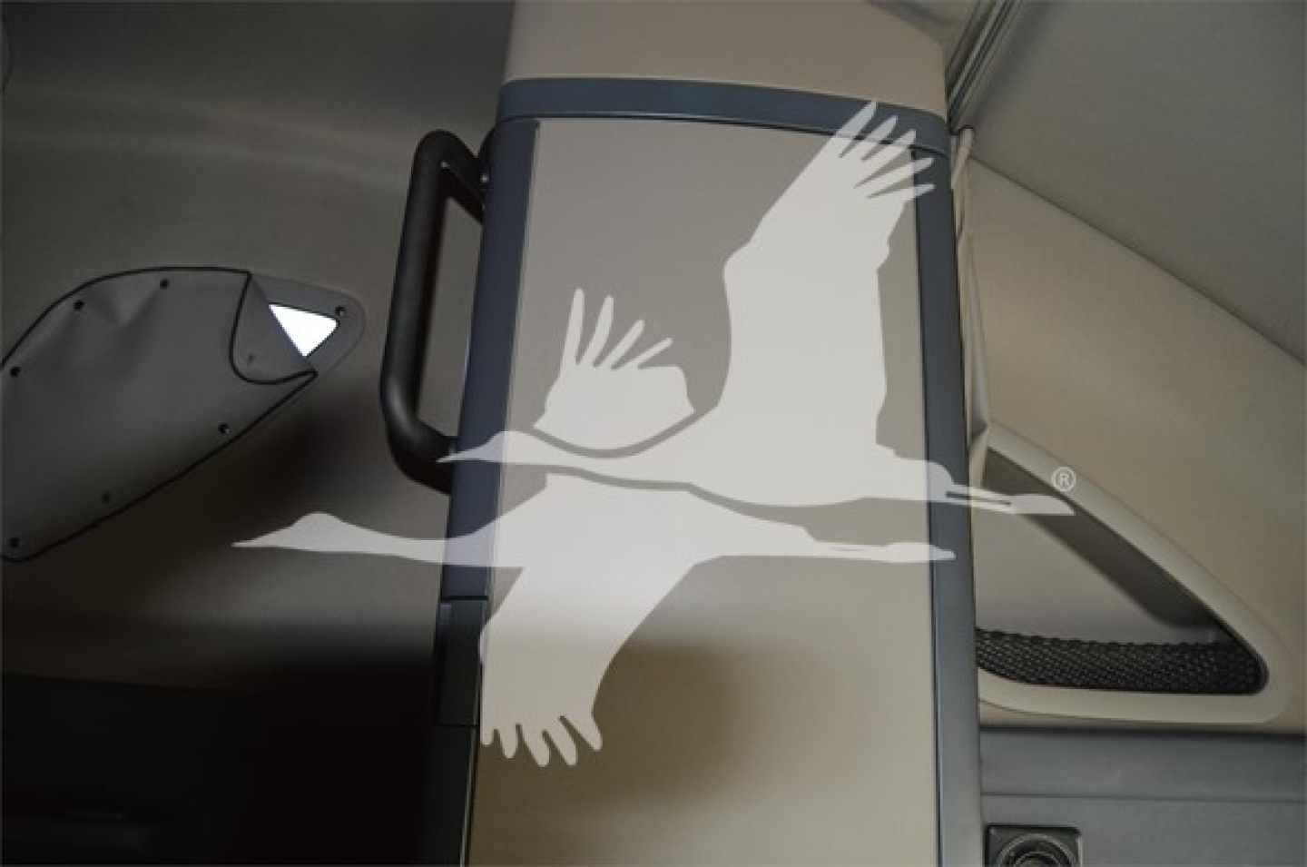 Truck interior pillar with graphic of a flying bird on side panel