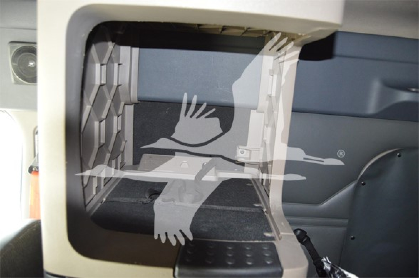 Cab interior view of a 2014 Freightliner Cascadia 125 Evolution sleeper with a focus on the storage compartment opening and step area.
