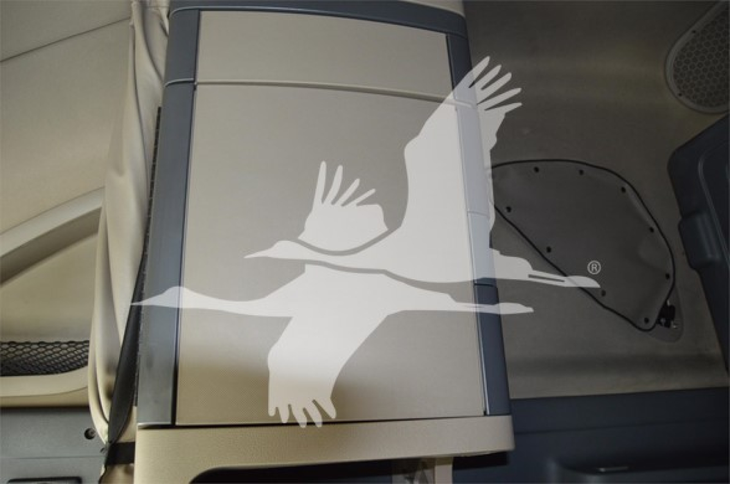 Cabin interior of a 2014 Freightliner Cascadia 125 Evolution showing overhead console and sleeper area with a decorative overlay.