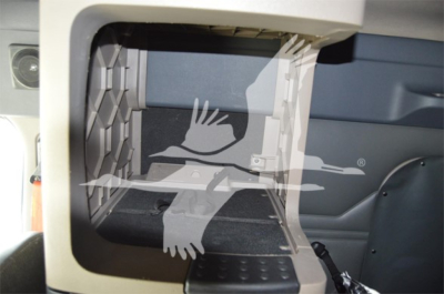 Cab interior view of a 2014 Freightliner Cascadia 125 Evolution sleeper with a focus on the storage compartment opening and step area.