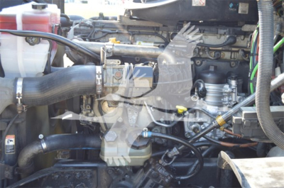Truck engine bay with hoses and components visible in a Freightliner Cascadia Evolution engine compartment.